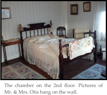 The chamber on the 2nd floor. Pictures of Mr. & Mrs. Otis hang on the wall.