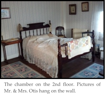 The chamber on the 2nd floor. Pictures of Mr. & Mrs. Otis hang on the wall.